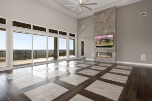 Living room of custom built home with marble fireplace