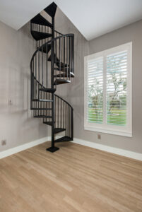 Spiral staircase in corner of custom luxury home