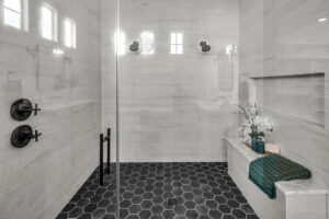 Luxury walk-in shower with black honeycomb floor and two shower heads