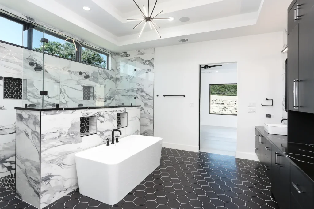 Cantera Hills bathroom with black honeycomb tile and black marble countertops.