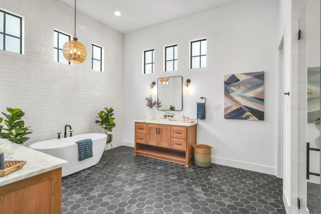 Bathroom with gray honeycomb tile and white tile backsplash.