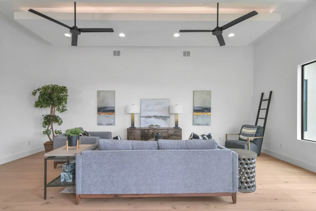 Living room inside of home in Bulverde with recessed lighting and tray ceiling.